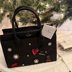 Kate Spade Black Satchel with Red and Pink Embellishments